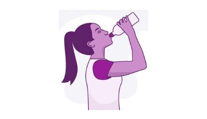 woman drinking water after working out
