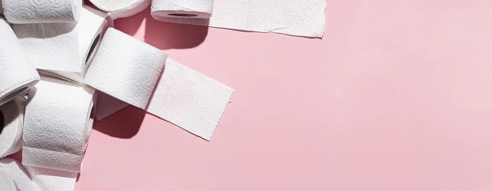 rolls of toilet paper on a pink background